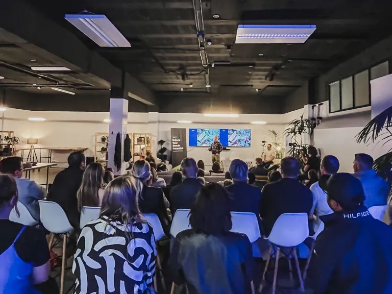 Waboom AI founder Leo speaking at a New Zealand AI workshop with a full audience