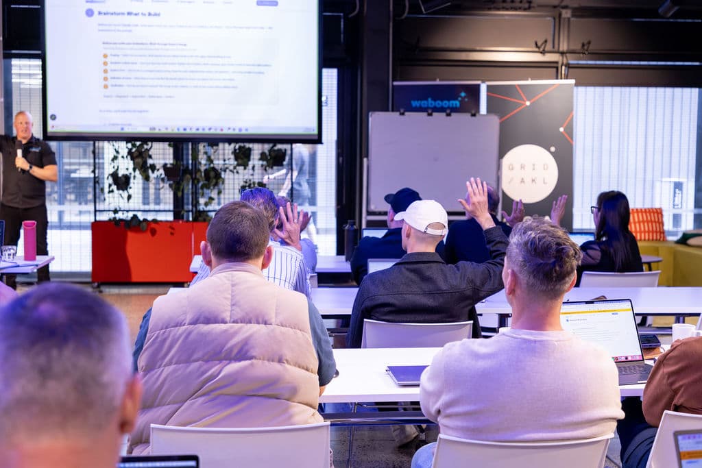 Leo running a live Waboom AI workshop, attendees raising their hands