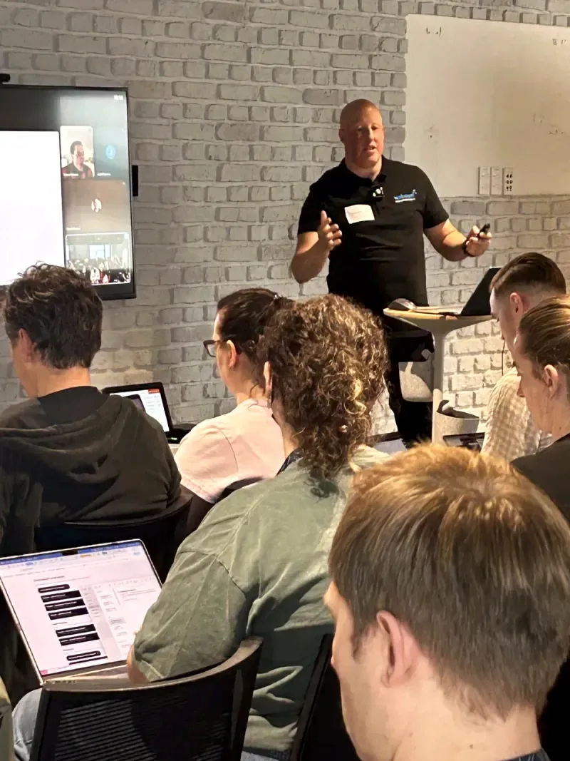Leo presenting a hybrid AI workshop to in person and remote attendees