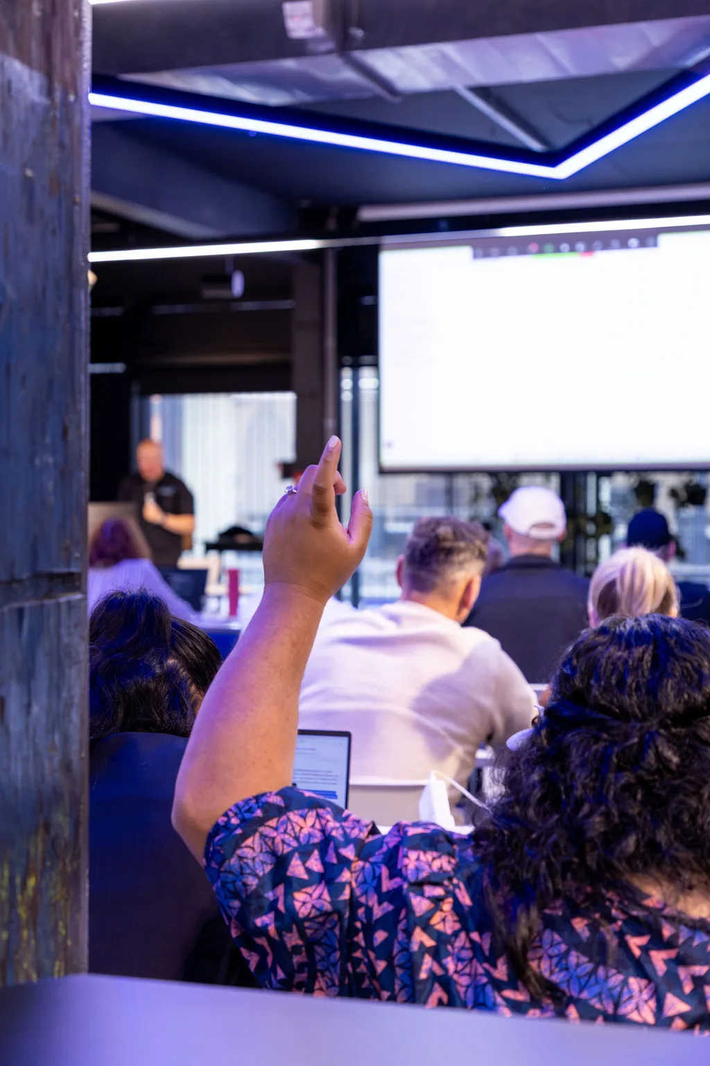 Workshop attendee raising hand during Q&A