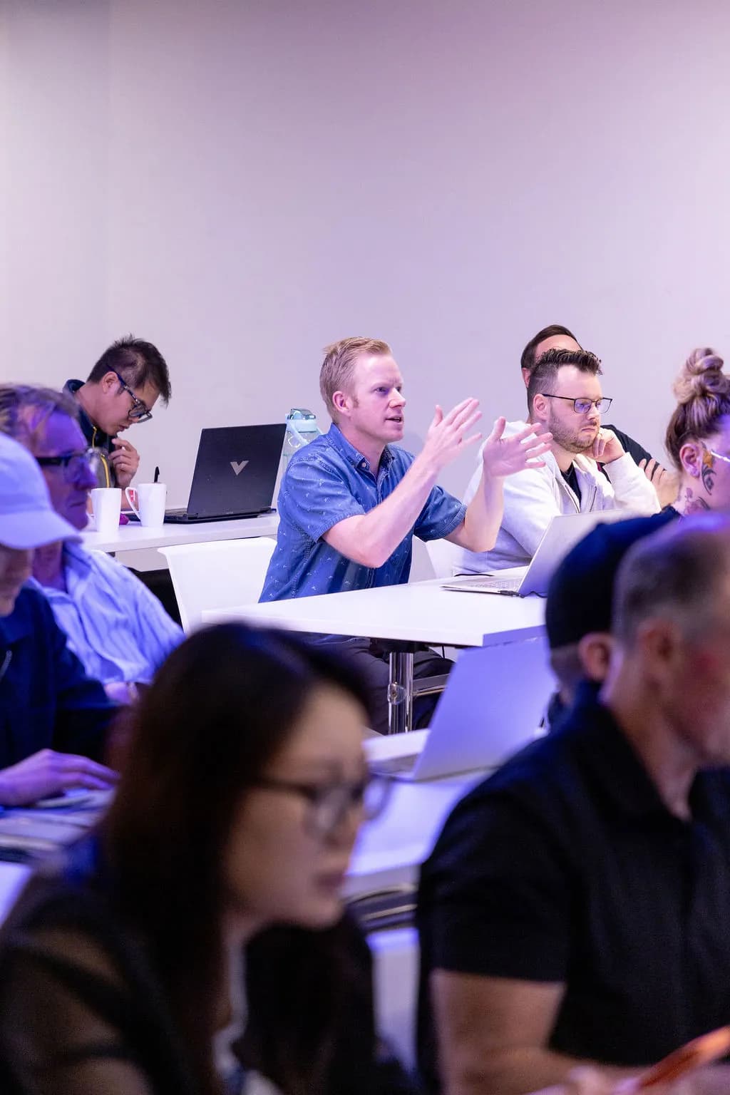 Attendee asking a question at a Waboom AI team training workshop in Auckland