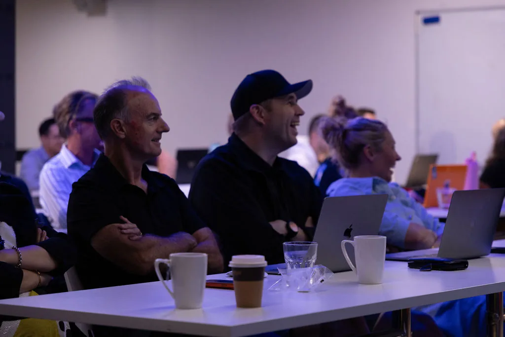 Attendees smiling during a Waboom AI training workshop session